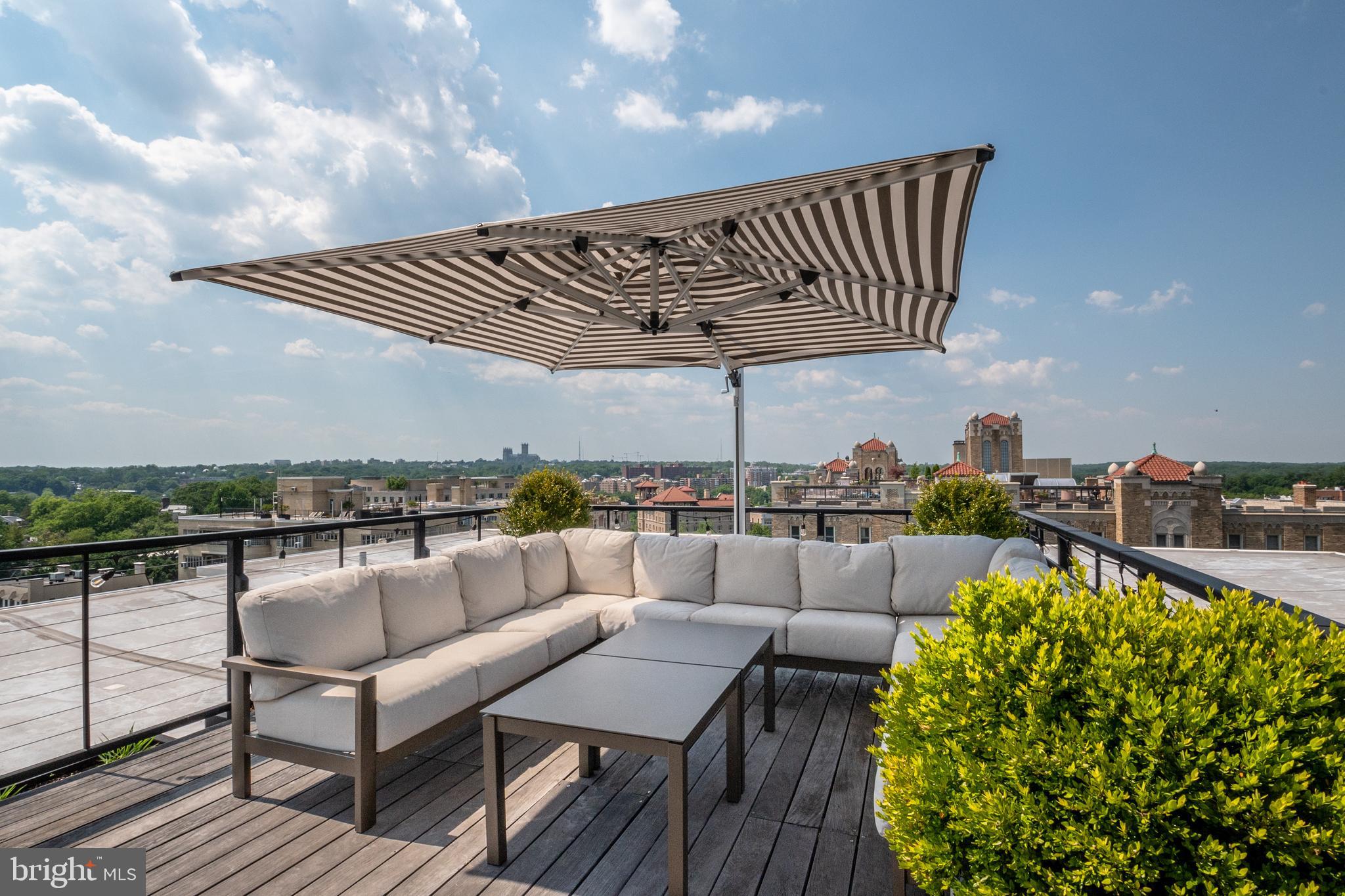 2029 Connecticut Avenue Northwest, Unit 42 Washington, DC 20008 - Photo 31 of 37 a roof deck with a table and chairs