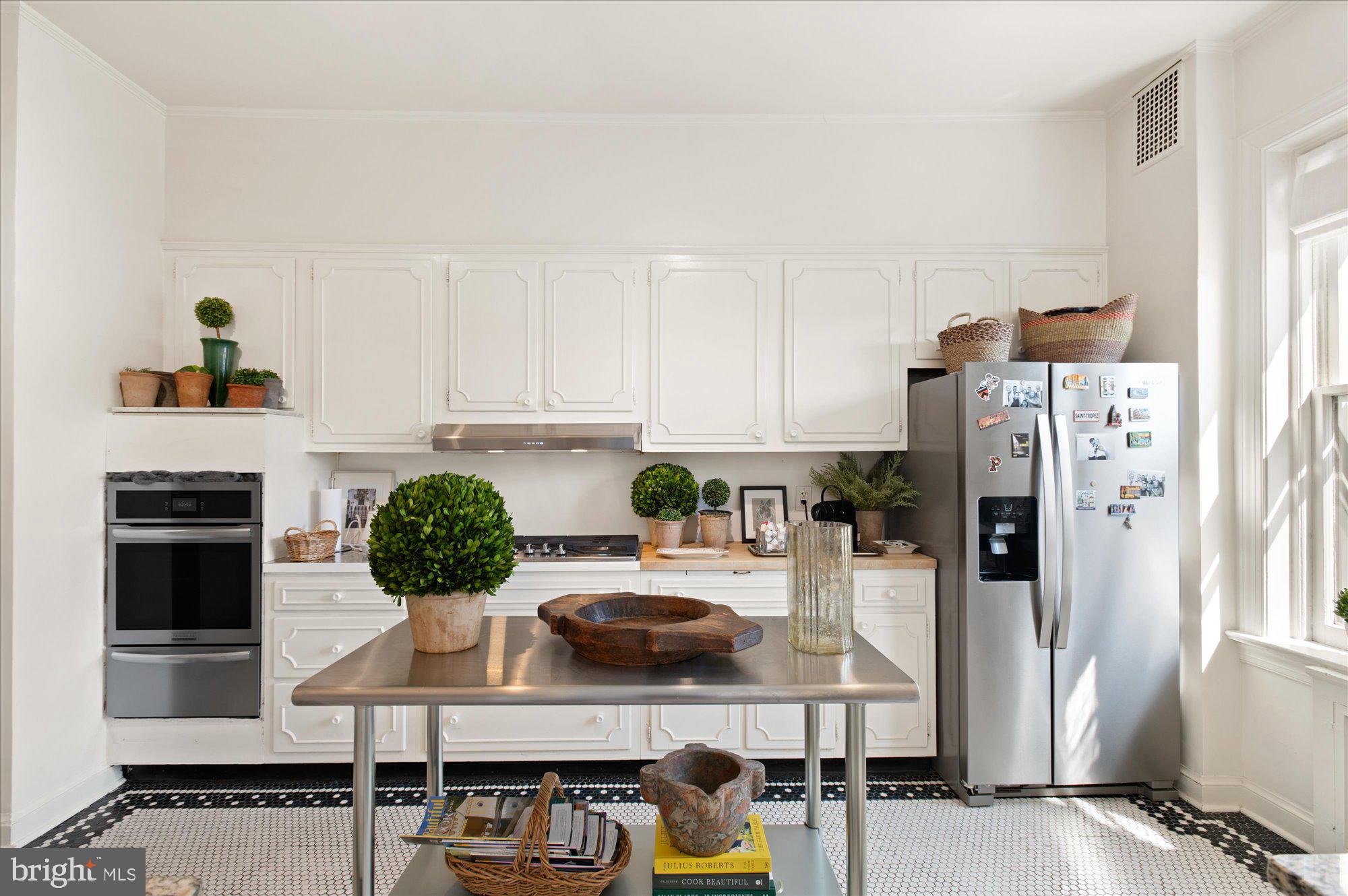 2029 Connecticut Avenue Northwest, Unit 42 Washington, DC 20008 - Photo 5 of 37 a kitchen with stainless steel appliances kitchen island granite countertop a refrigerator and stove