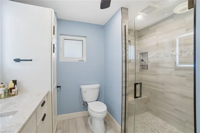 a bathroom with a toilet sink and shower