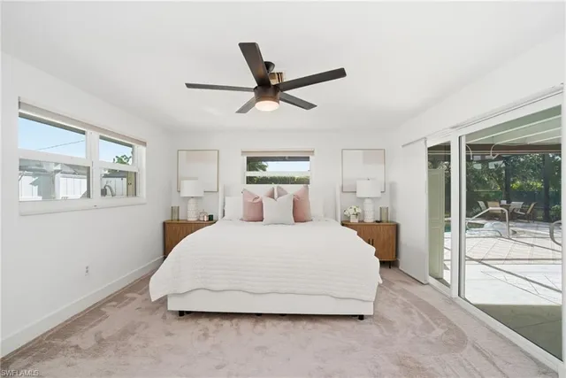 a bedroom with a large bed and a large window