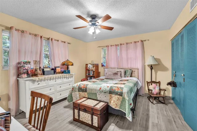 a bedroom with a bed a table and chair