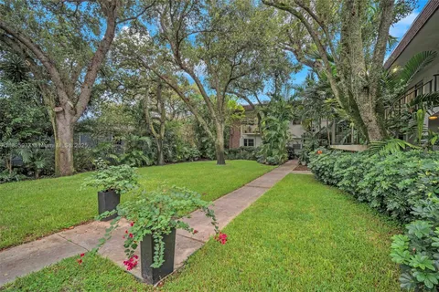 a view of a garden with wooden fence