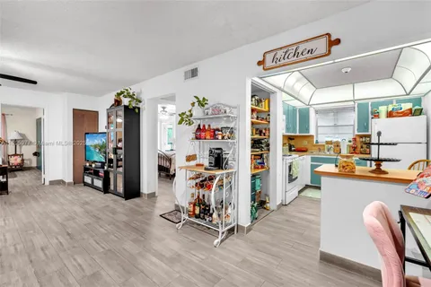 a view of a room with lots of wooden furniture