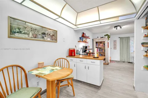 a view of a dining room with furniture and a chandelier