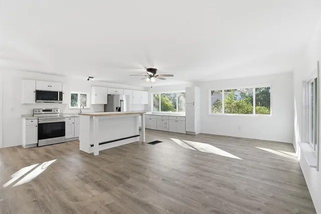 a view of a kitchen with microwave and cabinets