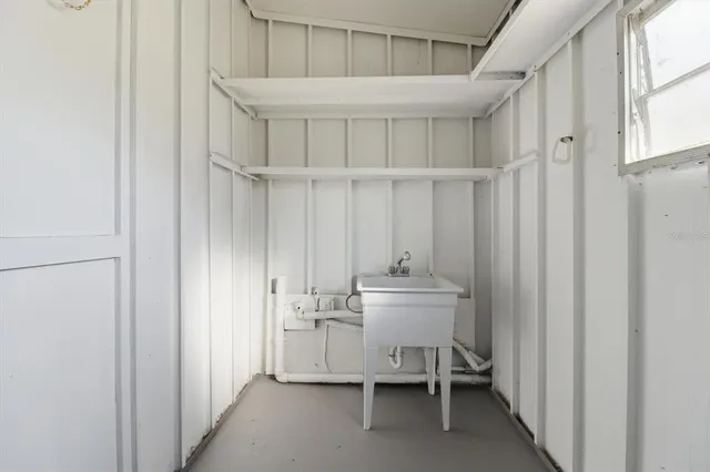 a view of kitchen with furniture and stainless steel appliances