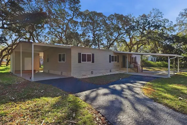 a view of a house with backyard and sitting area
