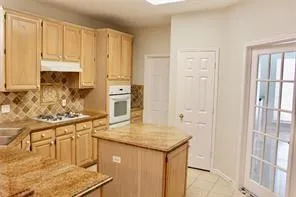 a kitchen with stainless steel appliances granite countertop a sink and cabinets