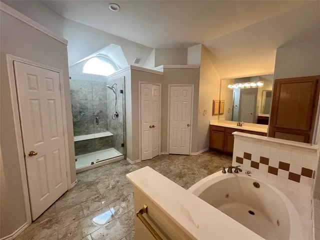 a bathroom with a tub sink and mirror