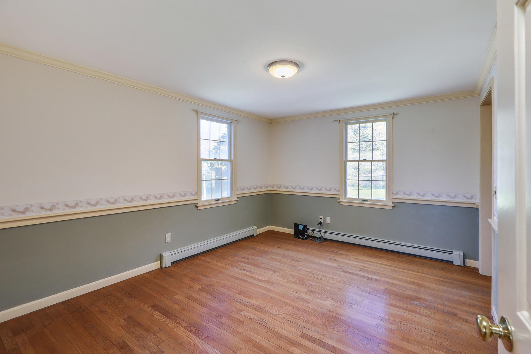 39 Sparrowhawk Road Orleans, MA 02653 - Photo 12 of 40 an empty room with wooden floor and windows