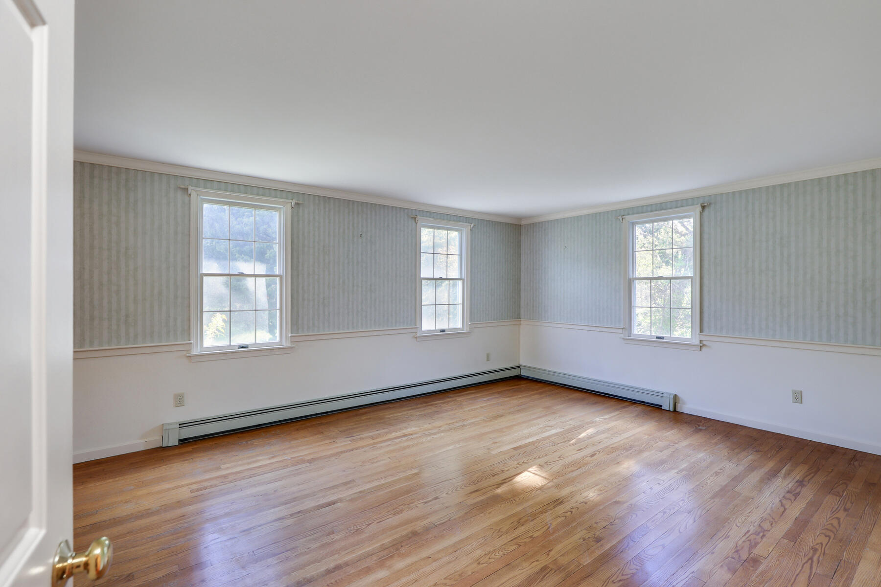 39 Sparrowhawk Road Orleans, MA 02653 - Photo 14 of 40 an empty room with wooden floor and windows