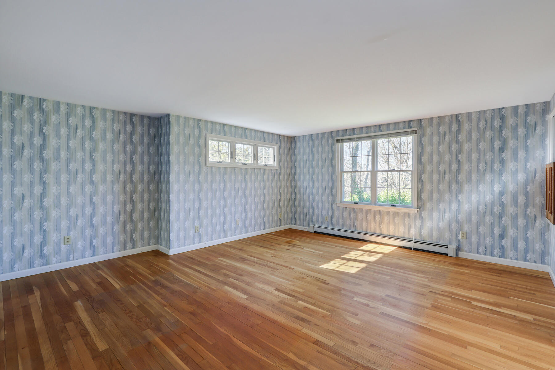 39 Sparrowhawk Road Orleans, MA 02653 - Photo 16 of 40 a view of an empty room with wooden floor and a window