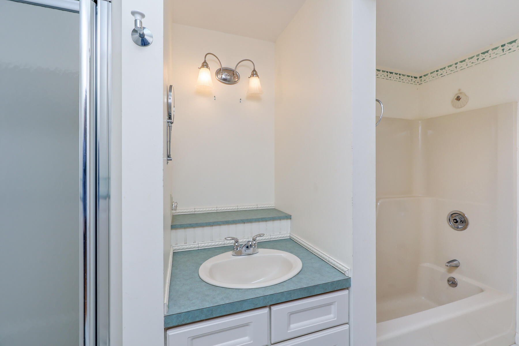 39 Sparrowhawk Road Orleans, MA 02653 - Photo 19 of 40 a bathroom with a granite countertop sink and a mirror