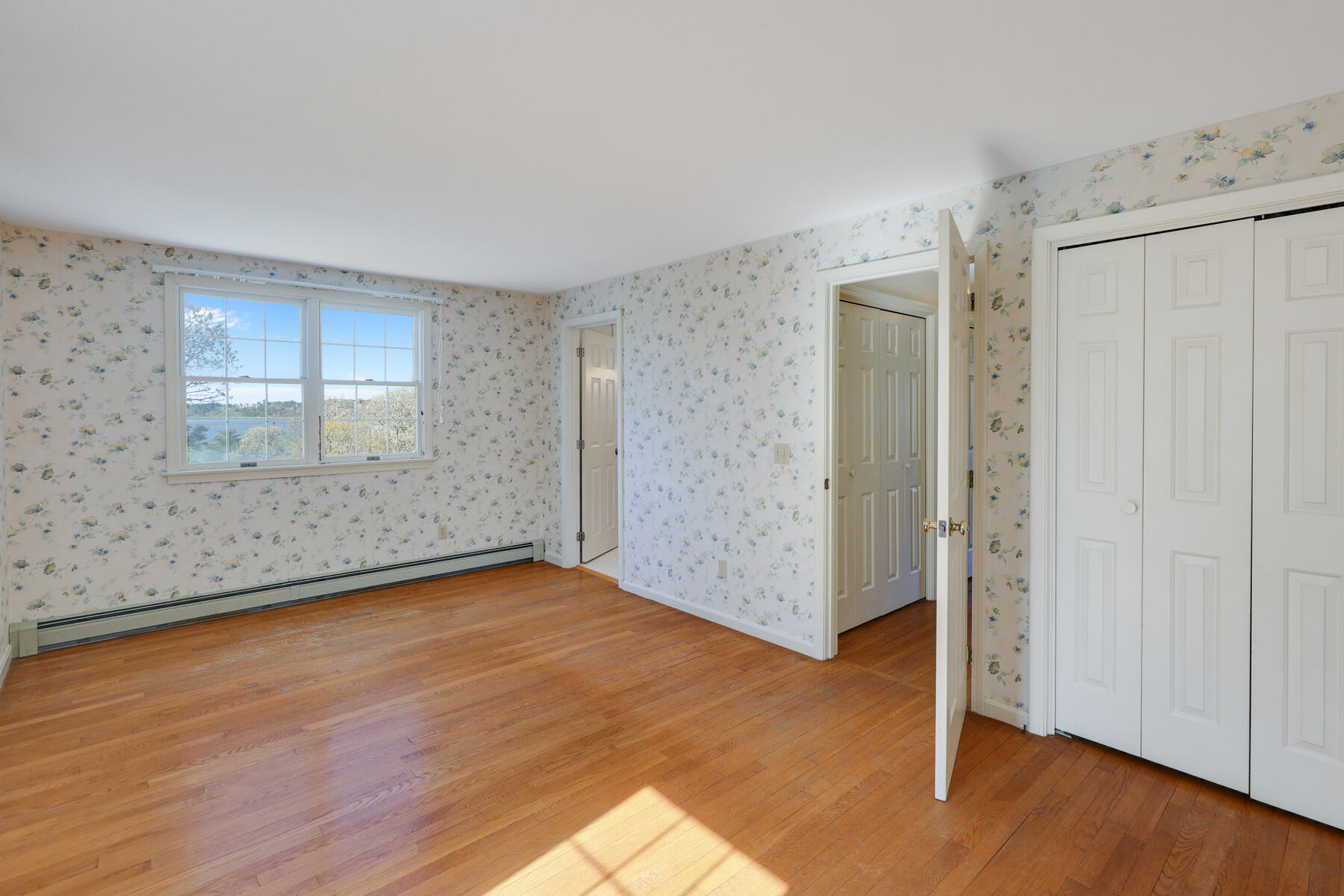 39 Sparrowhawk Road Orleans, MA 02653 - Photo 25 of 40 an empty room with wooden floor and windows