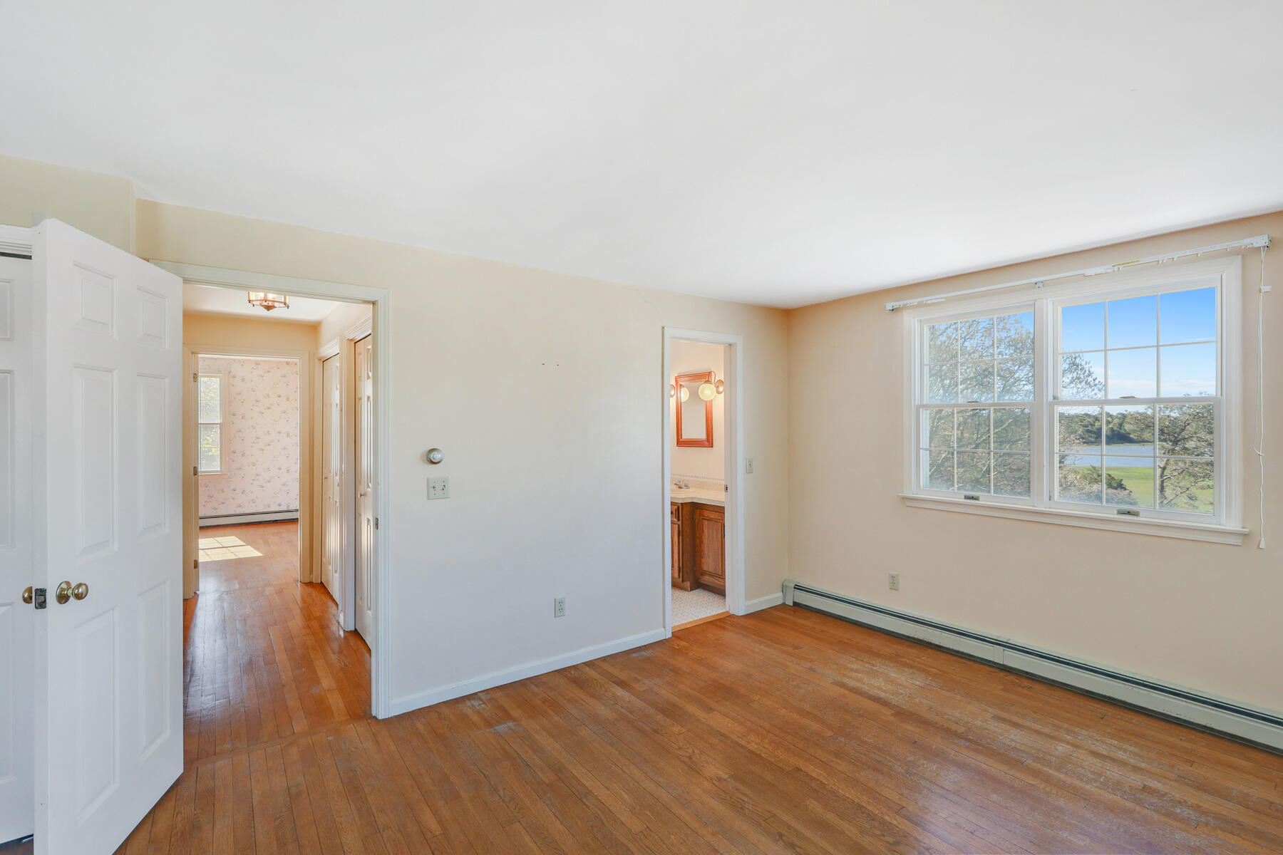 39 Sparrowhawk Road Orleans, MA 02653 - Photo 28 of 40 an empty room with wooden floor and windows