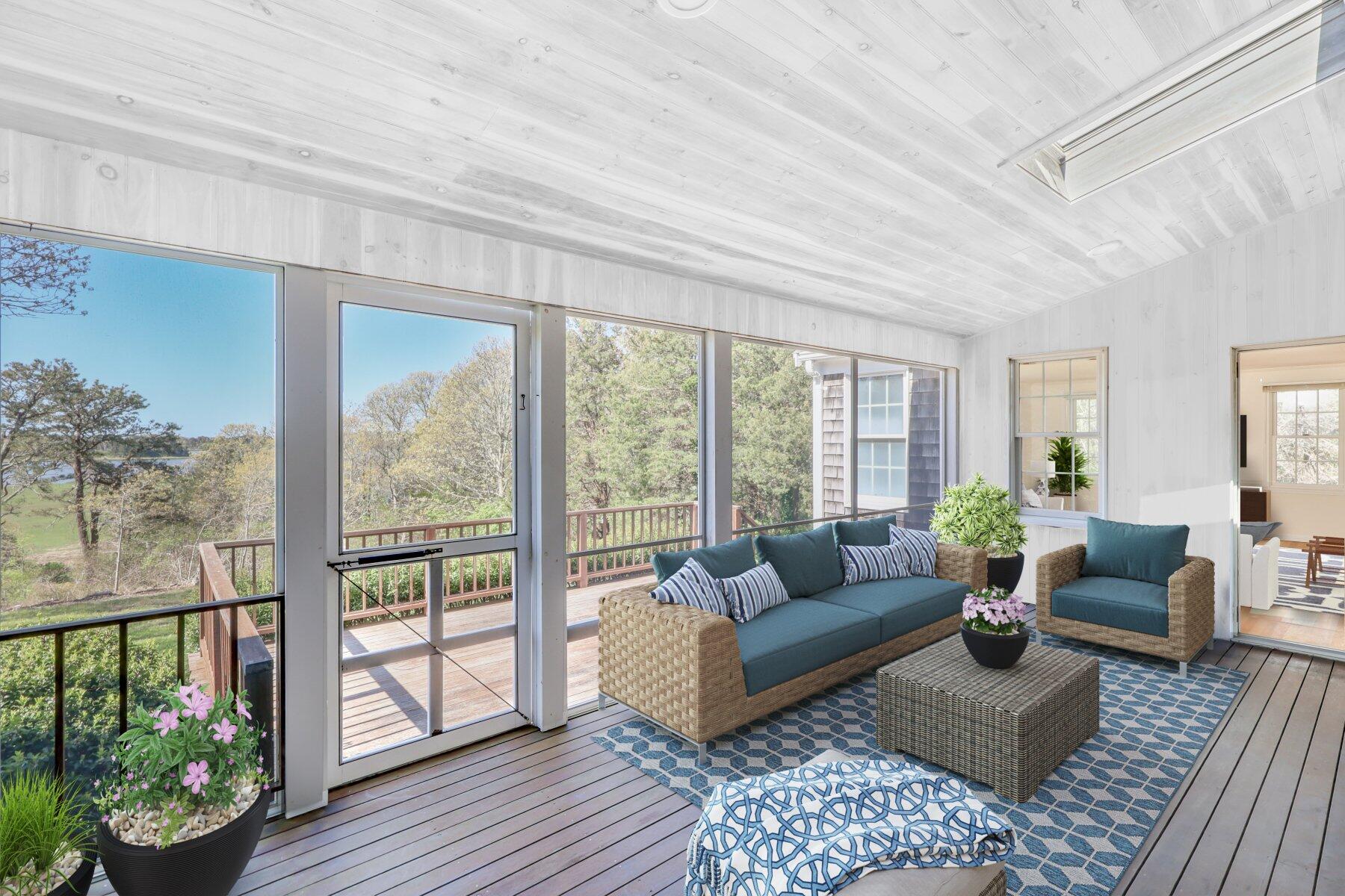 39 Sparrowhawk Road Orleans, MA 02653 - Photo 30 of 40 a living room with furniture and a floor to ceiling window
