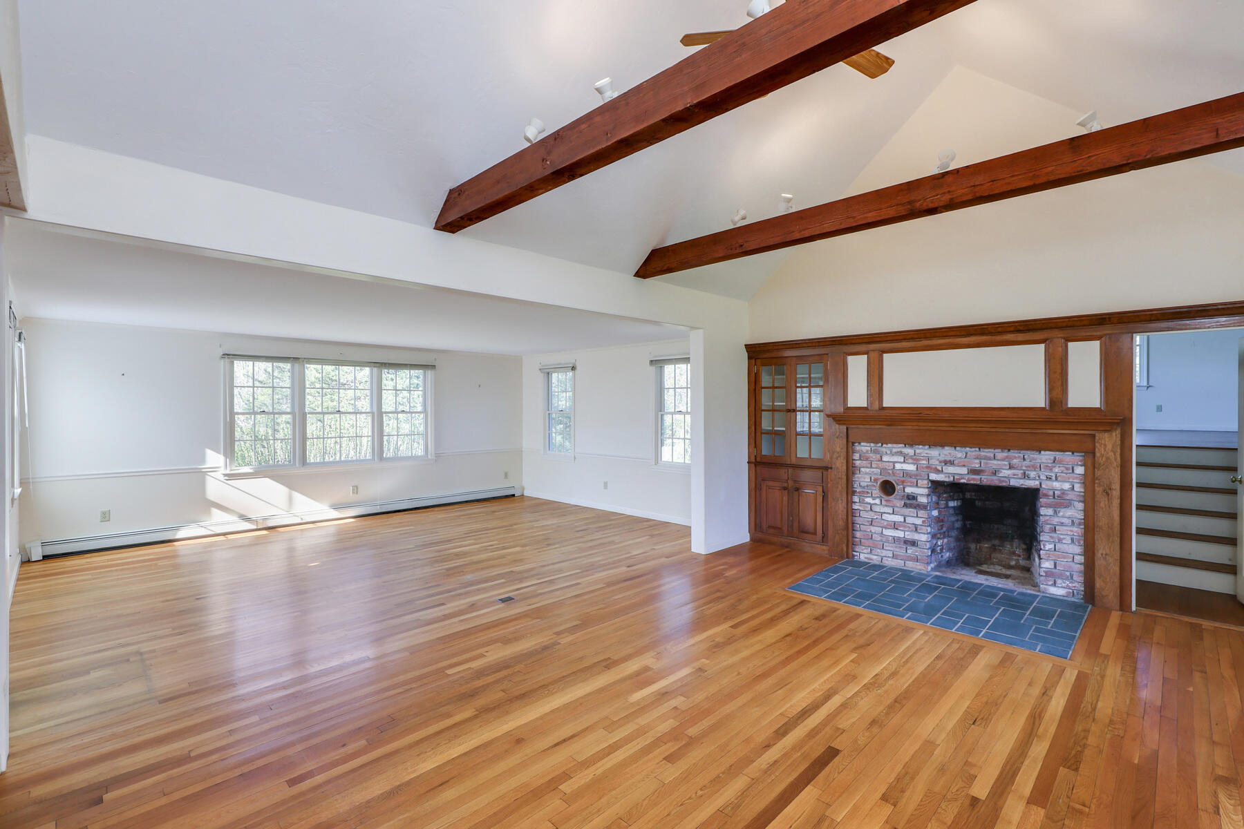 39 Sparrowhawk Road Orleans, MA 02653 - Photo 7 of 40 an empty room with wooden floor fireplace and windows