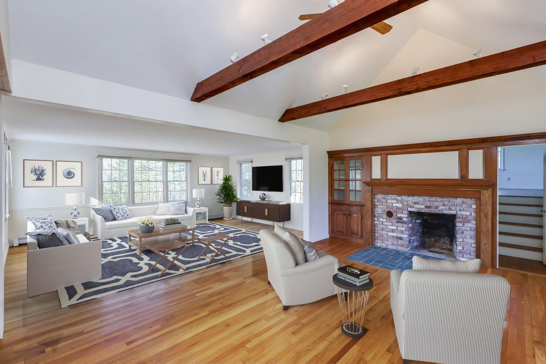 39 Sparrowhawk Road Orleans, MA 02653 - Photo 8 of 40 a living room with furniture fireplace and a large window