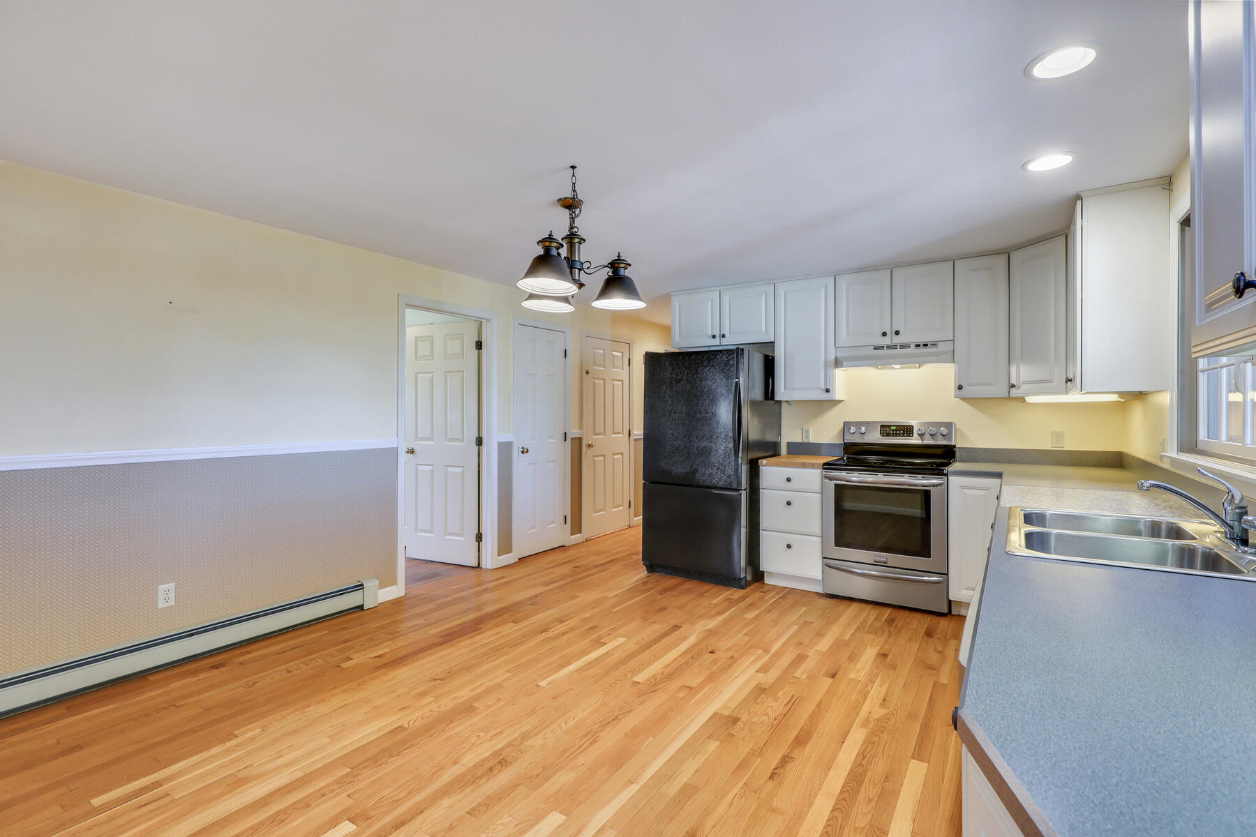 39 Sparrowhawk Road Orleans, MA 02653 - Photo 10 of 40 a kitchen with granite countertop a refrigerator stove top oven and sink