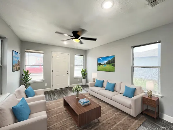 a living room with furniture and a chandelier