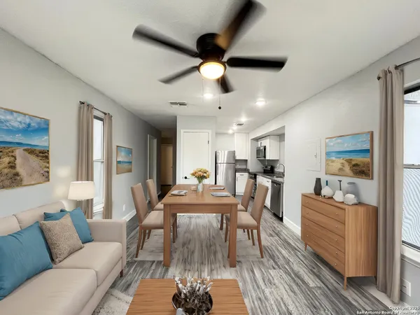 a view of a livingroom with furniture and a ceiling fan