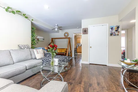 a living room with furniture fireplace and wooden floor