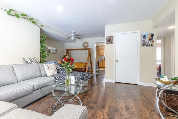 a living room with furniture fireplace and wooden floor