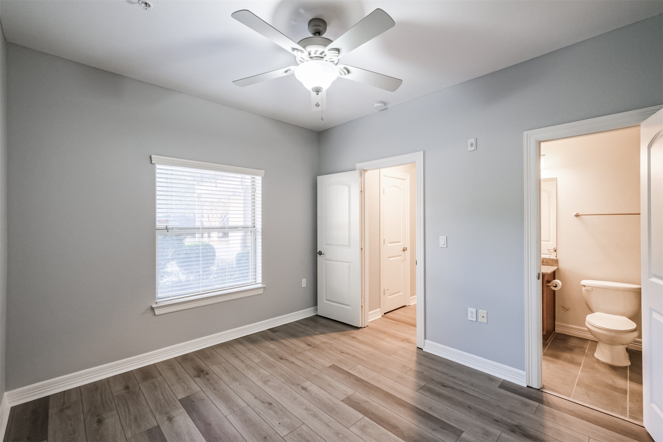 3501 Chenevert Street, Unit 7 Houston, TX 77004 - Photo 13 of 24 a view of an empty room with a window and wooden floor