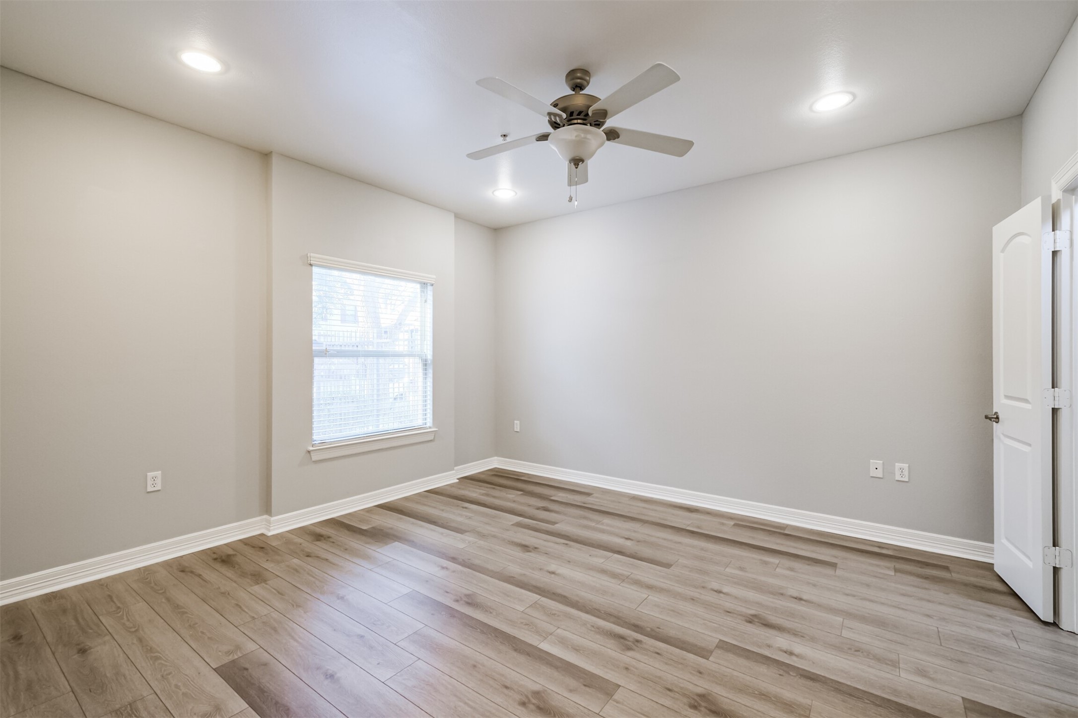 3501 Chenevert Street, Unit 7 Houston, TX 77004 - Photo 17 of 24 wooden floor in an empty room with a window