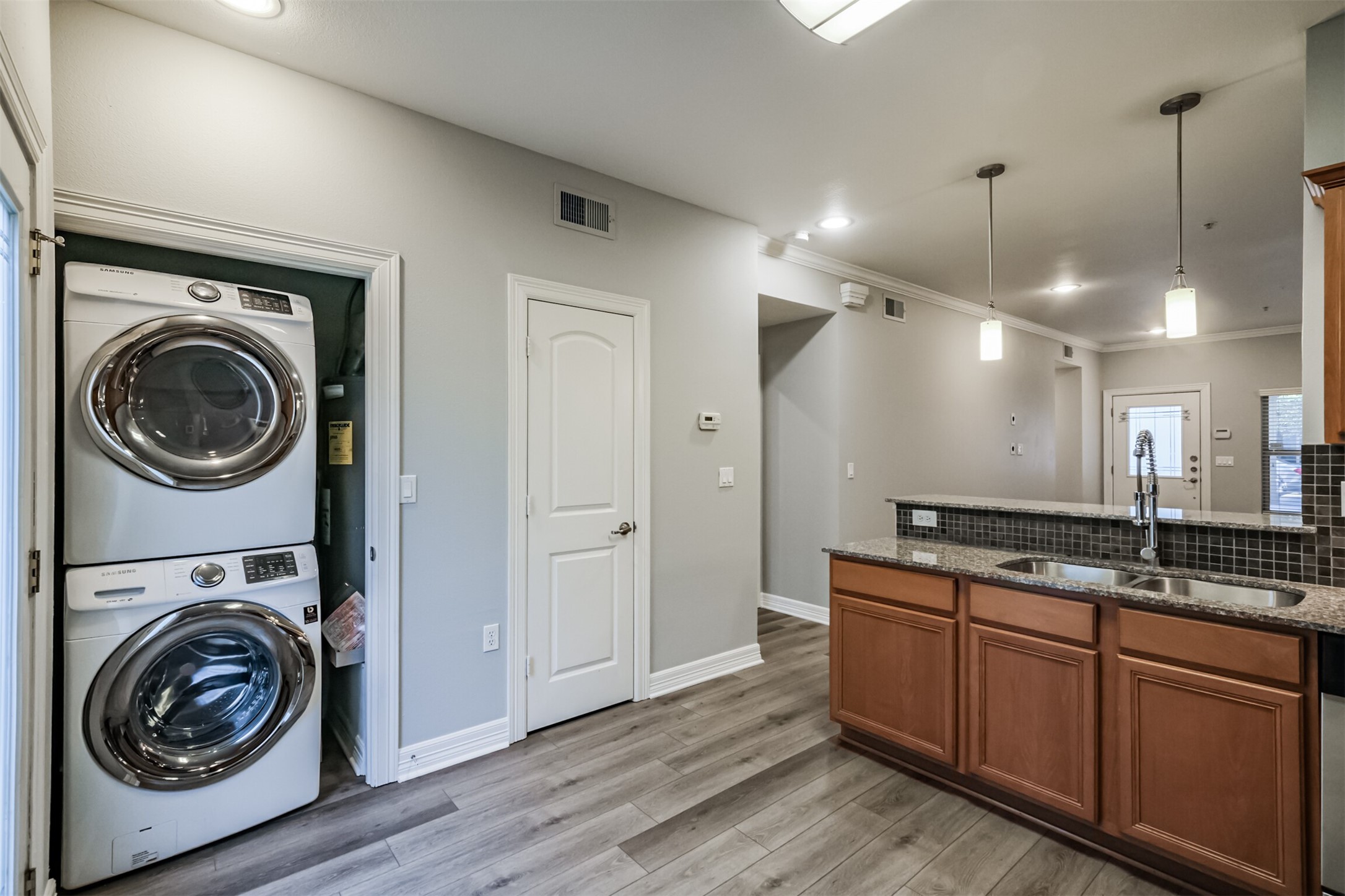 3501 Chenevert Street, Unit 7 Houston, TX 77004 - Photo 8 of 24 a view of a kitchen with a sink a washer and dryer