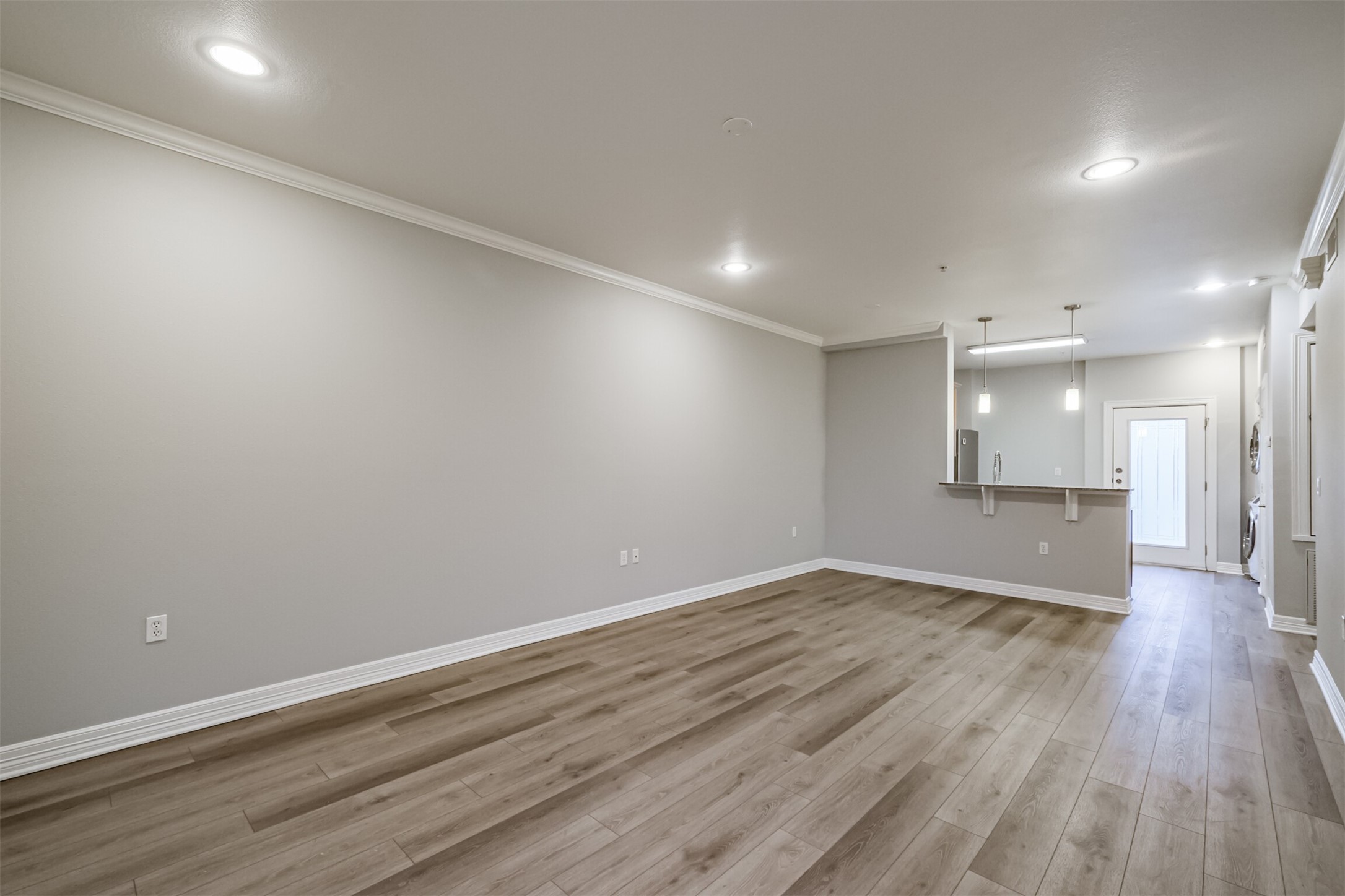 3501 Chenevert Street, Unit 7 Houston, TX 77004 - Photo 9 of 24 an empty room with wooden floor and windows