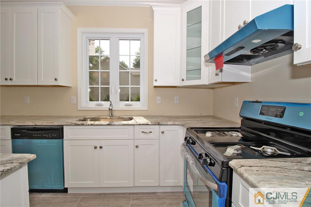 301 Plainfield Road Edison, NJ 08820 - Photo 14 of 25 a kitchen with a stove and a sink