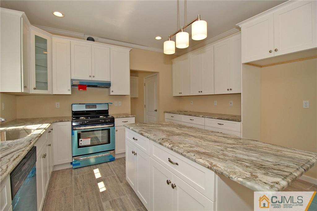301 Plainfield Road Edison, NJ 08820 - Photo 15 of 25 a kitchen with stainless steel appliances granite countertop a stove a sink and a granite counter tops