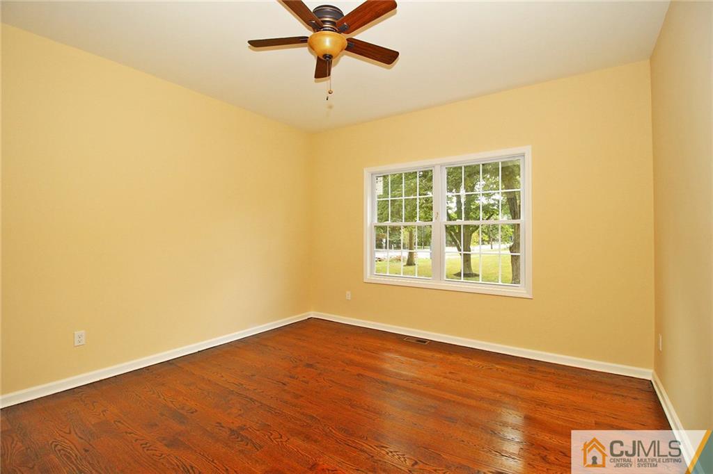 301 Plainfield Road Edison, NJ 08820 - Photo 18 of 25 a view of an empty room with wooden floor and a window