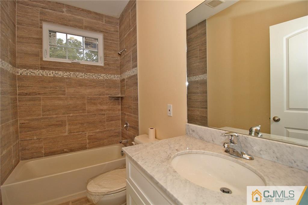301 Plainfield Road Edison, NJ 08820 - Photo 19 of 25 a bathroom with a granite countertop bathtub sink vanity mirror and toilet