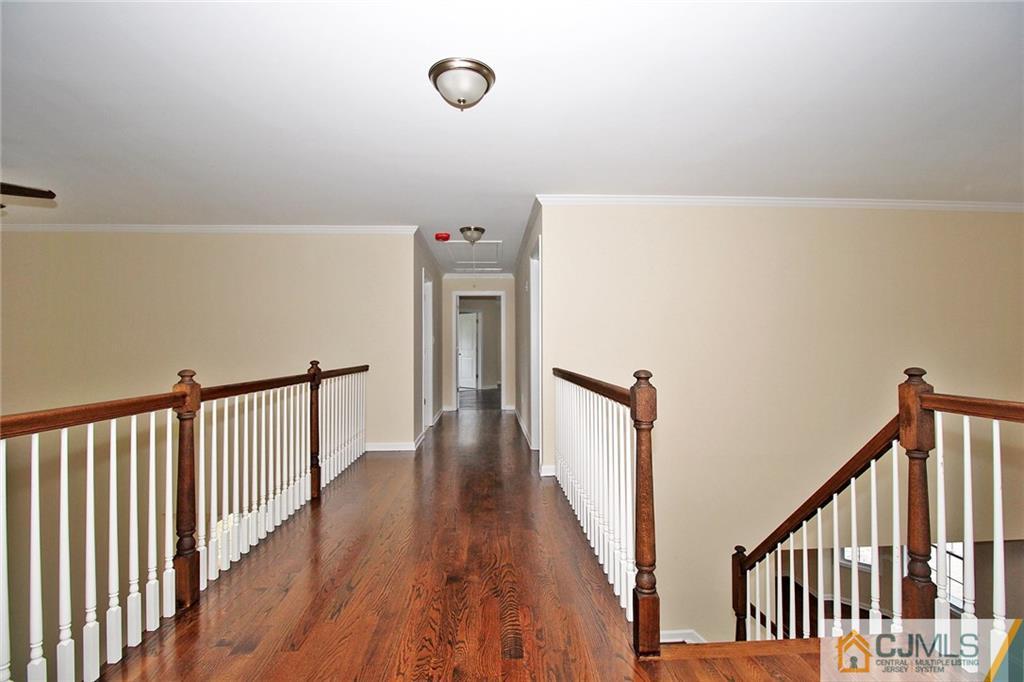 301 Plainfield Road Edison, NJ 08820 - Photo 20 of 25 a view of a hallway with wooden floor and stairs