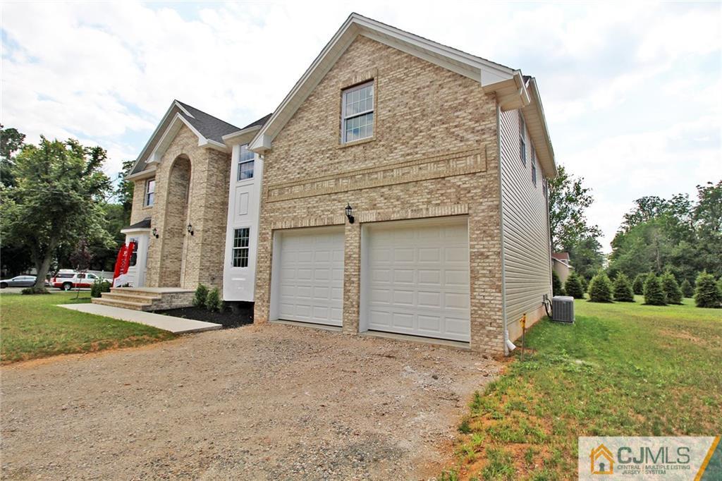 301 Plainfield Road Edison, NJ 08820 - Photo 3 of 25 a front view of a house with a yard and garage