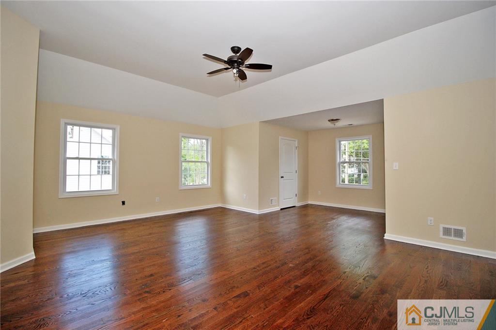 301 Plainfield Road Edison, NJ 08820 - Photo 21 of 25 a view of an empty room with a window and wooden floor