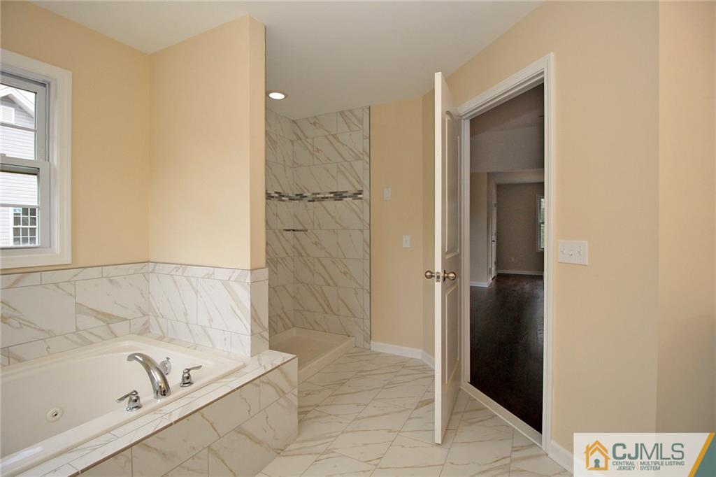 301 Plainfield Road Edison, NJ 08820 - Photo 22 of 25 a bathroom with a tub and a shower