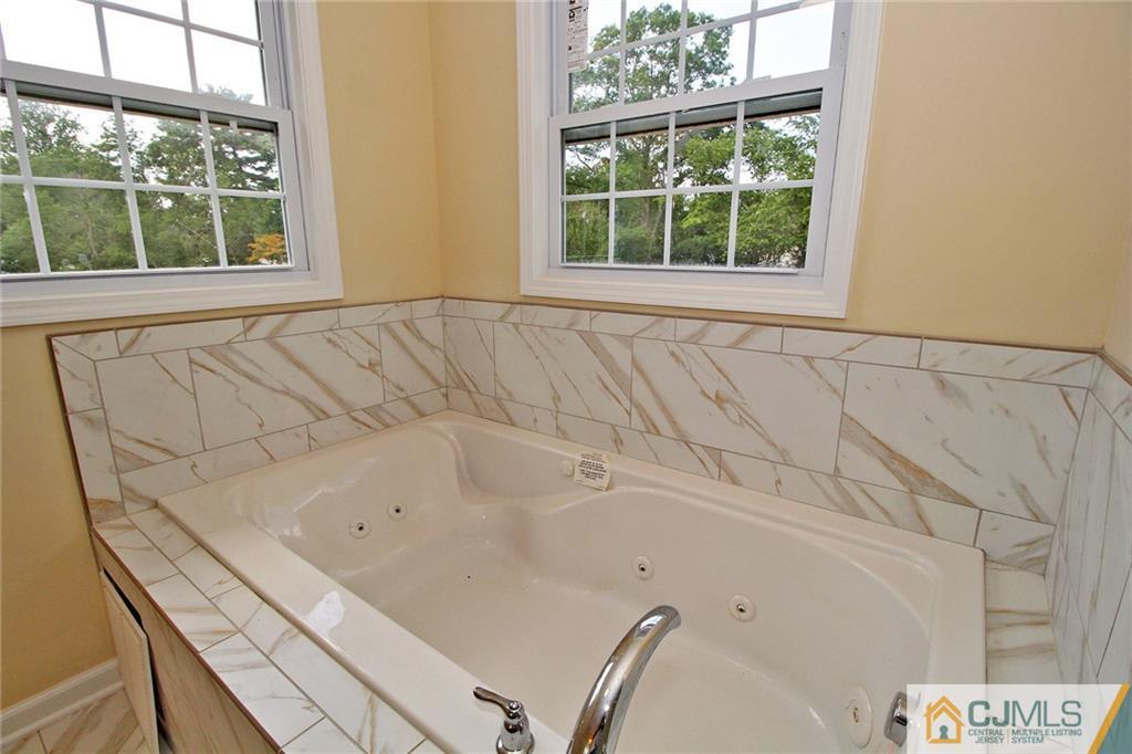 301 Plainfield Road Edison, NJ 08820 - Photo 23 of 25 a bathroom with a bathtub and a window