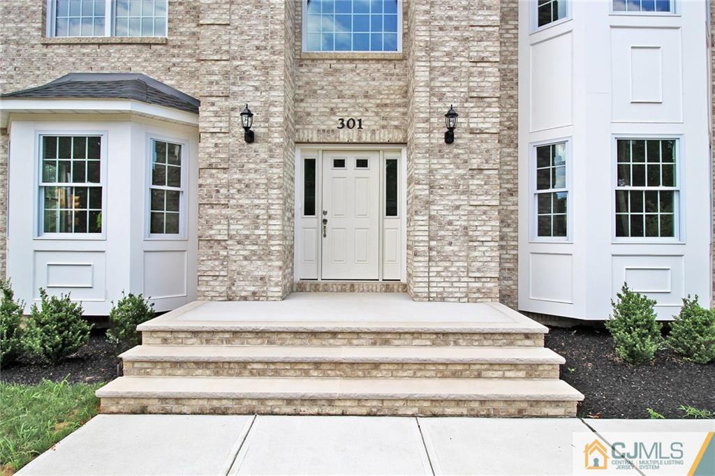 301 Plainfield Road Edison, NJ 08820 - Photo 4 of 25 a front view of a house with potted plants