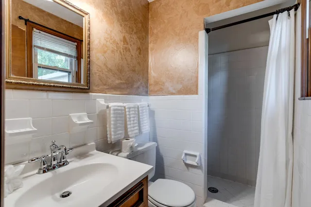 a bathroom with a sink toilet and shower