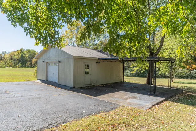 a view of a backyard with a tree
