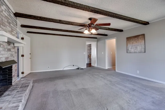 a view of an empty room with a fireplace