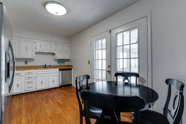 a kitchen with a table chairs and microwave