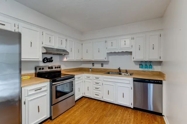a kitchen with stainless steel appliances granite countertop a sink and cabinets
