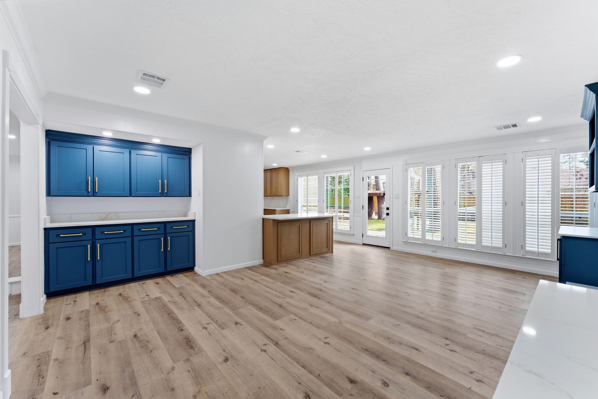 5203 Woodville Lane Spring, TX 77379 - Photo 13 of 50 Classic plantation shutters offer both privacy and a touch of sophisticated style to the main living areas.