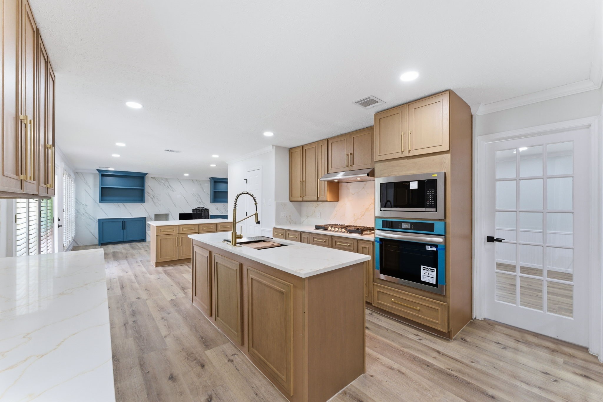 5203 Woodville Lane Spring, TX 77379 - Photo 19 of 50 With a massive central island and a perfectly integrated wall oven, this layout is designed for flow. Whether it’s a quick breakfast or a five-course dinner, there’s a place for everything (and everyone).