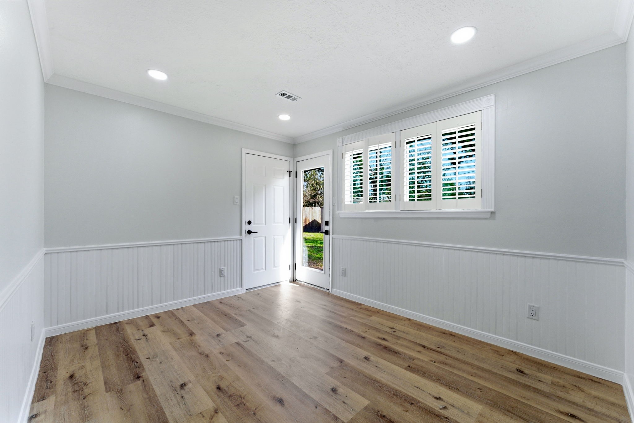 5203 Woodville Lane Spring, TX 77379 - Photo 20 of 50 Classic architectural details meet modern crispness. This flexible space, framed by elegant wall paneling and a private exit, is just waiting for a cozy breakfast table.