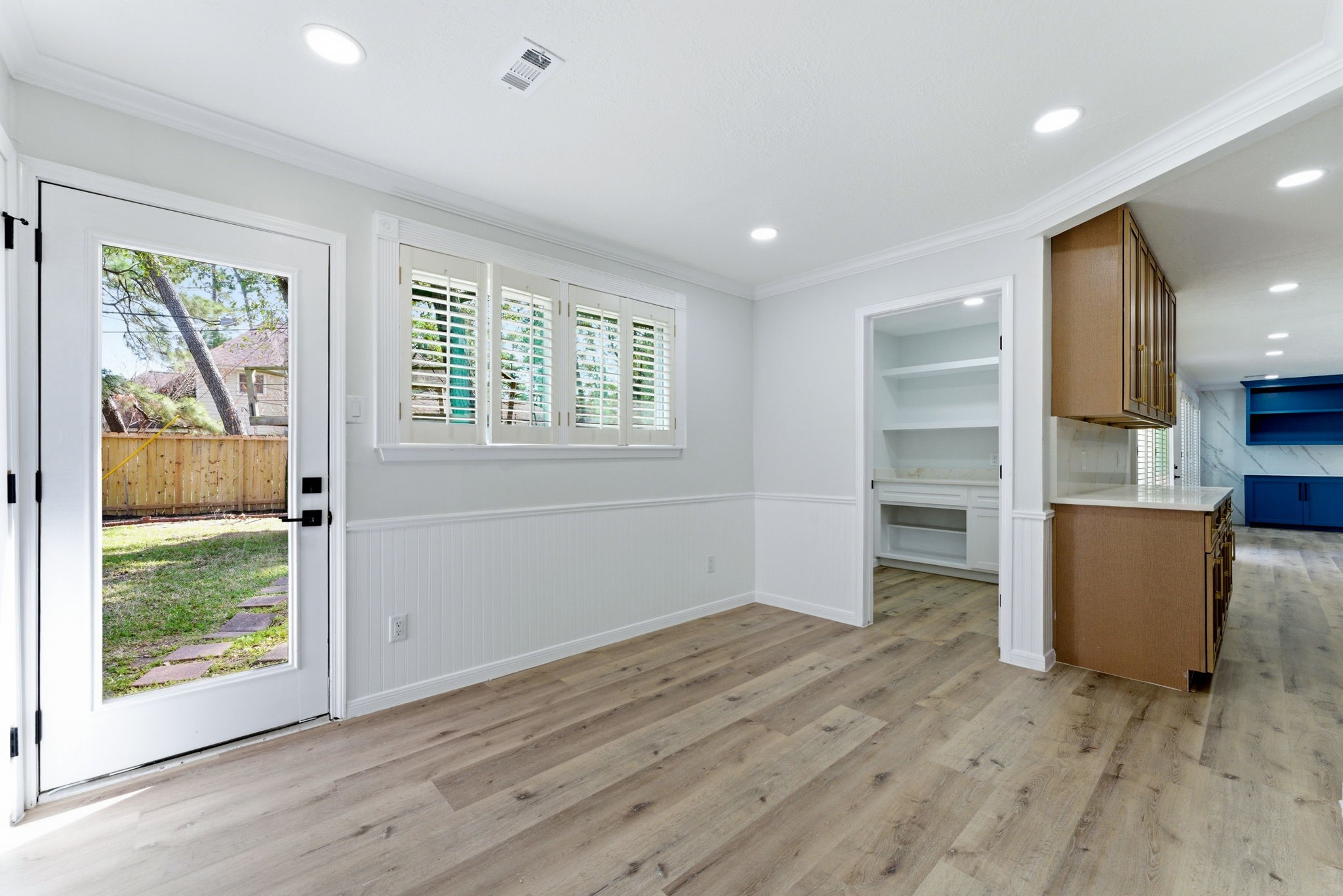 5203 Woodville Lane Spring, TX 77379 - Photo 21 of 50 This perspective highlights the home's intuitive layout, connecting the bright dining area directly to the utility hub and the heart of the kitchen.